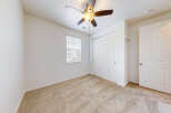 Step into this inviting bedroom featuring a plush carpeted floor and a convenient ceiling fan for year-round comfort.