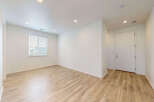 Step into this bright and airy living space featuring a large window that floods the room with natural light.