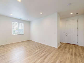 Step into this bright and airy living space featuring a large window that floods the room with natural light.