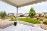 Enjoy outdoor living from this covered patio overlooking a spacious backyard.