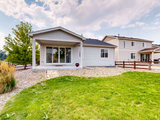Enjoy outdoor living with this charming home featuring a covered patio perfect for entertaining.