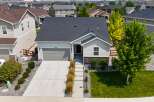 Discover this charming single-family home featuring a modern gray garage door and a welcoming light gray exterior.