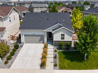 Discover this charming single-family home featuring a modern gray garage door and a welcoming light gray exterior.