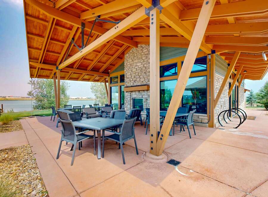 Enjoy outdoor dining and relaxation on this spacious patio, complete with comfortable seating and a stunning lake view.