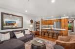 Experience modern living in this beautifully appointed open-concept space, featuring a sleek kitchen with ample cabinetry and a breakfast bar perfect for casual dining.
