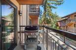 Enjoy outdoor living on this charming balcony, complete with a Weber grill perfect for summer cookouts.