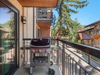 Enjoy outdoor living on this charming balcony, complete with a Weber grill perfect for summer cookouts.