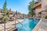 Enjoy a refreshing dip in this stunning outdoor pool, surrounded by lush greenery and breathtaking mountain views.