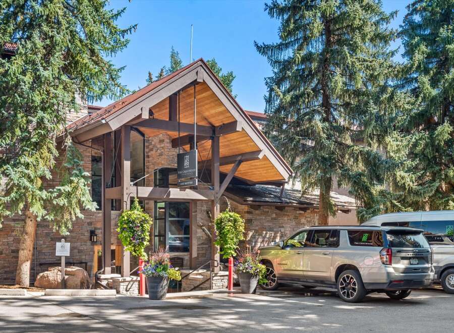 Experience the charm of The Crestwood, a distinguished hotel nestled amidst towering pine trees.