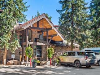 Experience the charm of The Crestwood, a distinguished hotel nestled amidst towering pine trees.
