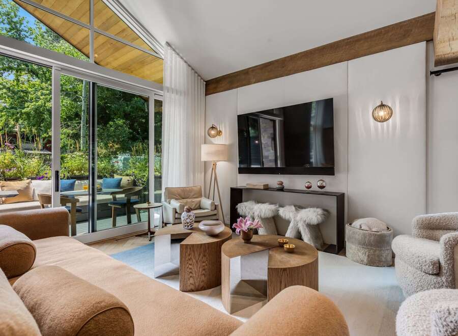 Experience modern living in this stunning living room, featuring a large sectional sofa and a sleek entertainment center.