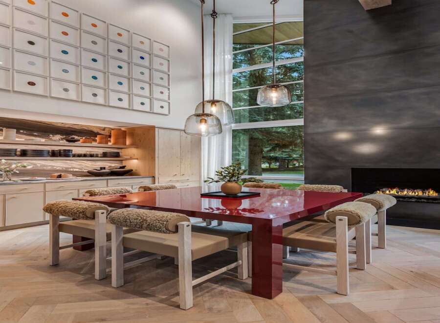 Experience modern luxury in this stunning dining area, featuring a vibrant red dining table as the centerpiece.