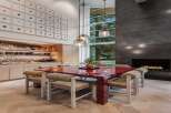 Experience modern luxury in this stunning dining area, featuring a vibrant red dining table as the centerpiece.