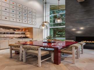Experience modern luxury in this stunning dining area, featuring a vibrant red dining table as the centerpiece.