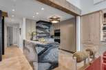 Experience luxury in this stunning kitchen featuring a dramatic marble island and backsplash.