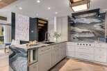 Experience luxury in this stunning modern kitchen, featuring a dramatic marble waterfall island and a captivating marble backsplash.