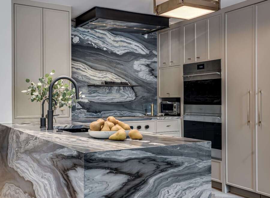 Experience luxury in this stunning kitchen, featuring a dramatic marble island and backsplash that command attention.