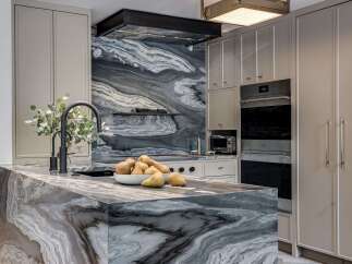 Experience luxury in this stunning kitchen, featuring a dramatic marble island and backsplash that command attention.