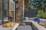 Enjoy your morning coffee and croissants on this charming patio, complete with a built-in seating area and lush greenery.