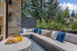 Enjoy your morning coffee on this charming outdoor patio, complete with a built-in sectional sofa and plush cushions.
