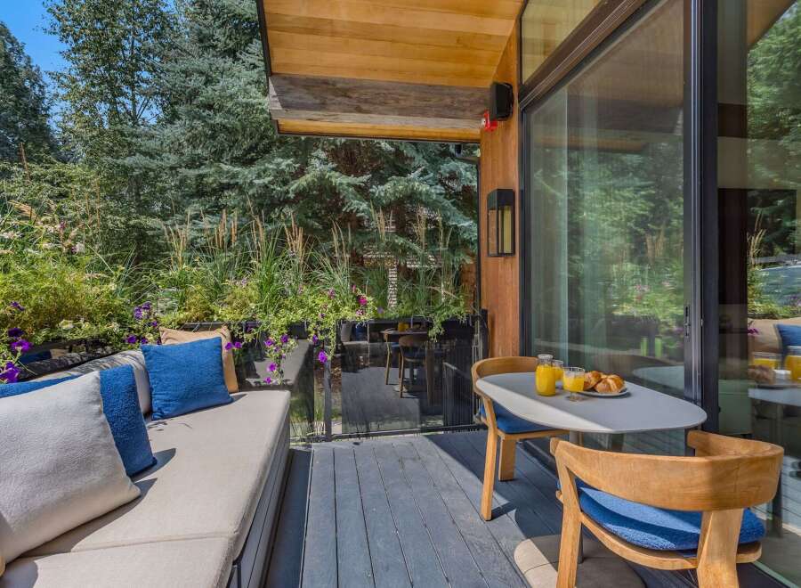 Enjoy your morning coffee on this charming patio, complete with a comfortable outdoor seating area and a dining set perfect for al fresco meals.