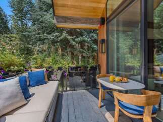 Enjoy your morning coffee on this charming patio, complete with a comfortable outdoor seating area and a dining set perfect for al fresco meals.