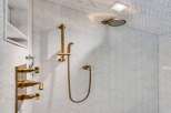 Experience luxury in this modern bathroom featuring a stunning herringbone tile shower.