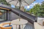 Enjoy breathtaking mountain views from this stunning outdoor living space, complete with a modern metal roof and a cozy seating area.