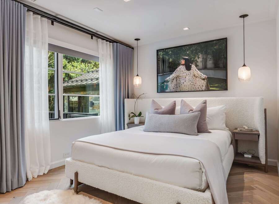 Experience serene comfort in this beautifully appointed bedroom, featuring a plush, textured bed as the centerpiece.