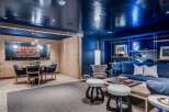 Step into a stylish entertainment space featuring a sleek, high-gloss navy ceiling that adds a dramatic flair.