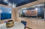 Experience a unique and stylish kitchen area featuring a stunning display of candy on open shelving, perfect for a fun and inviting atmosphere.