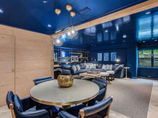 Experience luxurious living in this stunning entertainment space, featuring a deep navy blue ceiling and walls that create a dramatic and sophisticated ambiance.