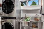 This modern laundry room features a stacked LG washer and dryer set, offering space-saving efficiency.