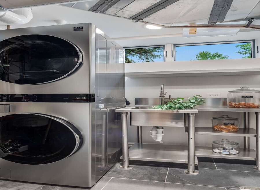 Discover modern convenience in this laundry room, featuring a sleek LG stackable washer and dryer set.