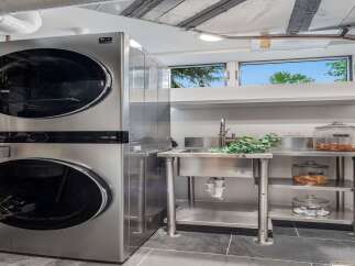 Discover modern convenience in this laundry room, featuring a sleek LG stackable washer and dryer set.