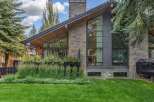 Experience modern luxury in this stunning home featuring a striking stone and dark metal exterior.