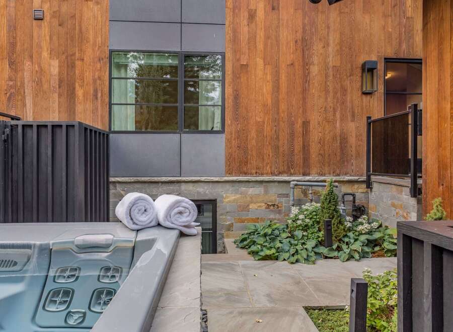 Experience ultimate relaxation with this luxurious outdoor spa, complemented by plush rolled towels for your comfort.
