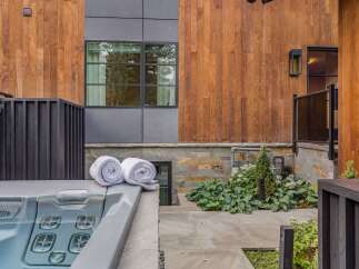 Experience ultimate relaxation with this luxurious outdoor spa, complemented by plush rolled towels for your comfort.