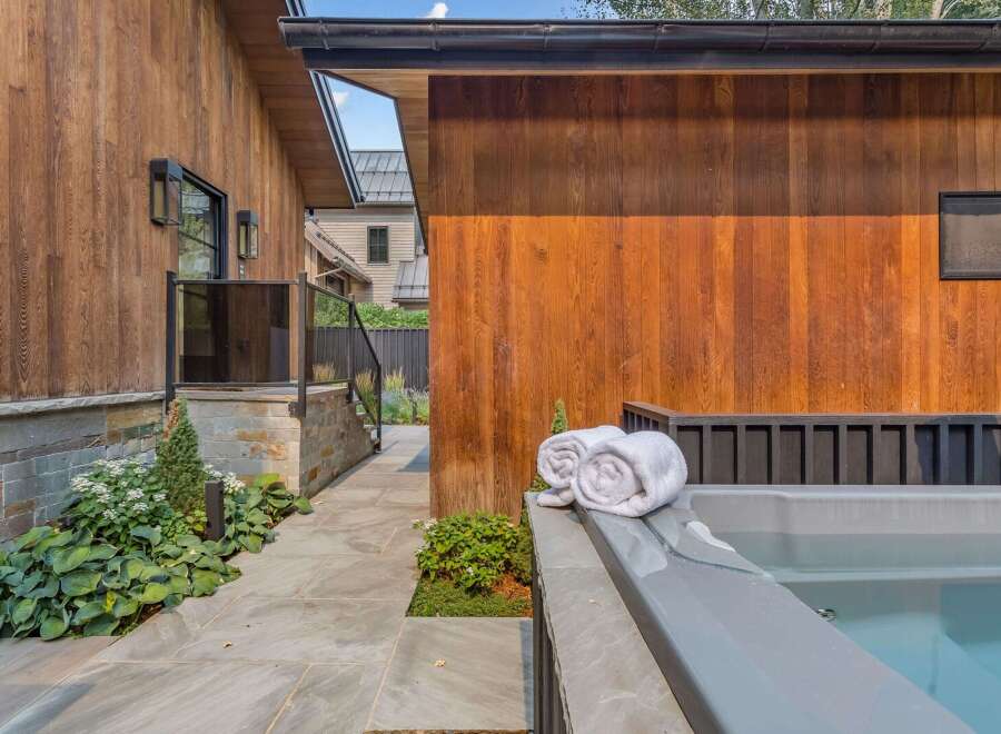 Experience ultimate relaxation in this modern backyard oasis, featuring a luxurious hot tub perfect for unwinding.