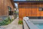 Experience ultimate relaxation in this modern backyard oasis, featuring a luxurious hot tub perfect for unwinding.