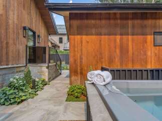 Experience ultimate relaxation in this modern backyard oasis, featuring a luxurious hot tub perfect for unwinding.
