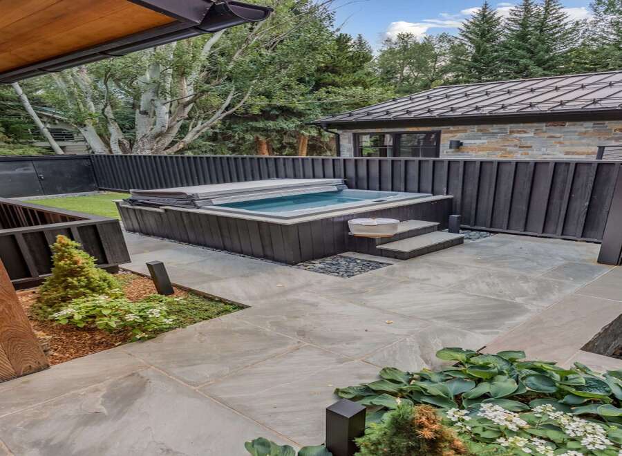 Experience ultimate relaxation in this modern backyard oasis, featuring a sleek, built-in hot tub perfect for unwinding.