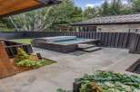 Experience ultimate relaxation in this modern backyard oasis, featuring a sleek, built-in hot tub perfect for unwinding.