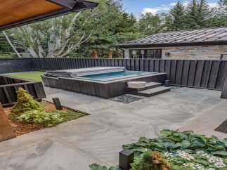 Experience ultimate relaxation in this modern backyard oasis, featuring a sleek, built-in hot tub perfect for unwinding.