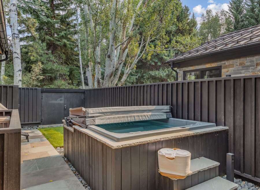 Experience ultimate relaxation in this backyard oasis, featuring a luxurious hot tub perfect for unwinding after a long day.