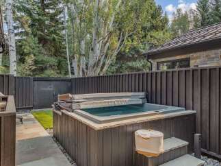 Experience ultimate relaxation in this backyard oasis, featuring a luxurious hot tub perfect for unwinding after a long day.