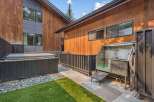 Experience outdoor luxury with this property's modern amenities, including a covered hot tub perfect for relaxation and a professional-grade outdoor dog grooming station.