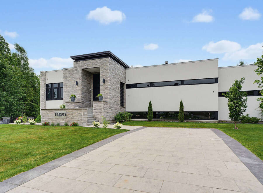 Discover modern luxury in this stunning architectural home, featuring a striking stone facade and sleek, minimalist design.