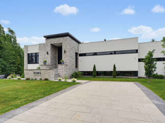 Discover modern luxury in this stunning architectural home, featuring a striking stone facade and sleek, minimalist design.
