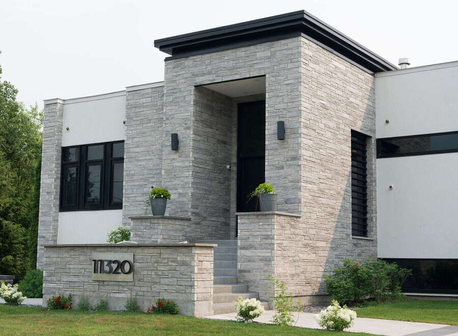 Discover modern luxury in this stunning home featuring a striking stone facade and sleek architectural lines.